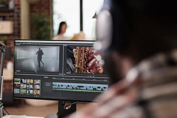 Young freelancer editing footage on software